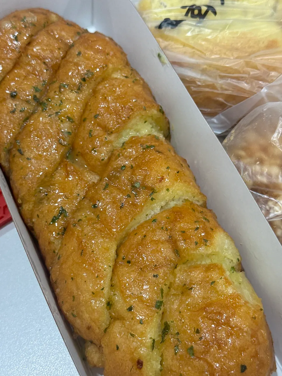 A single piece of Munhwa Bakery garlic bread