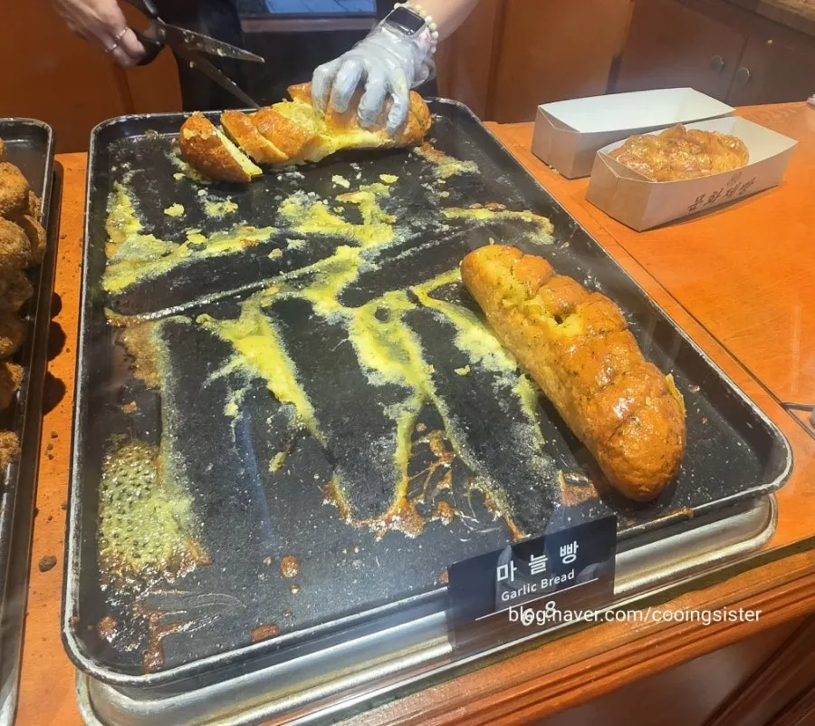 Freshly baked bread waiting on a cart tray at Munhwa Bakery