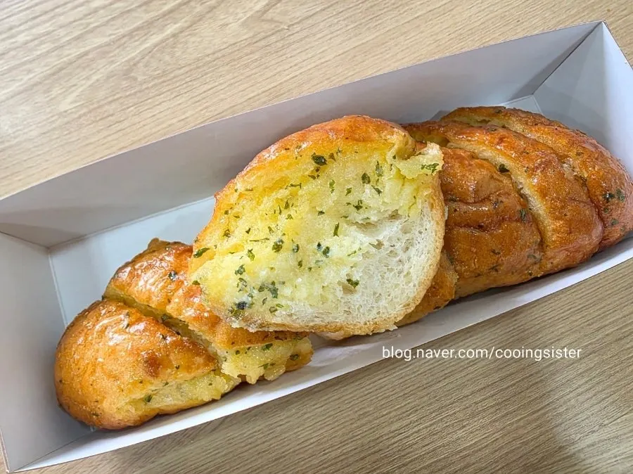Cross-section of garlic bread full of garlic condensed milk sauce