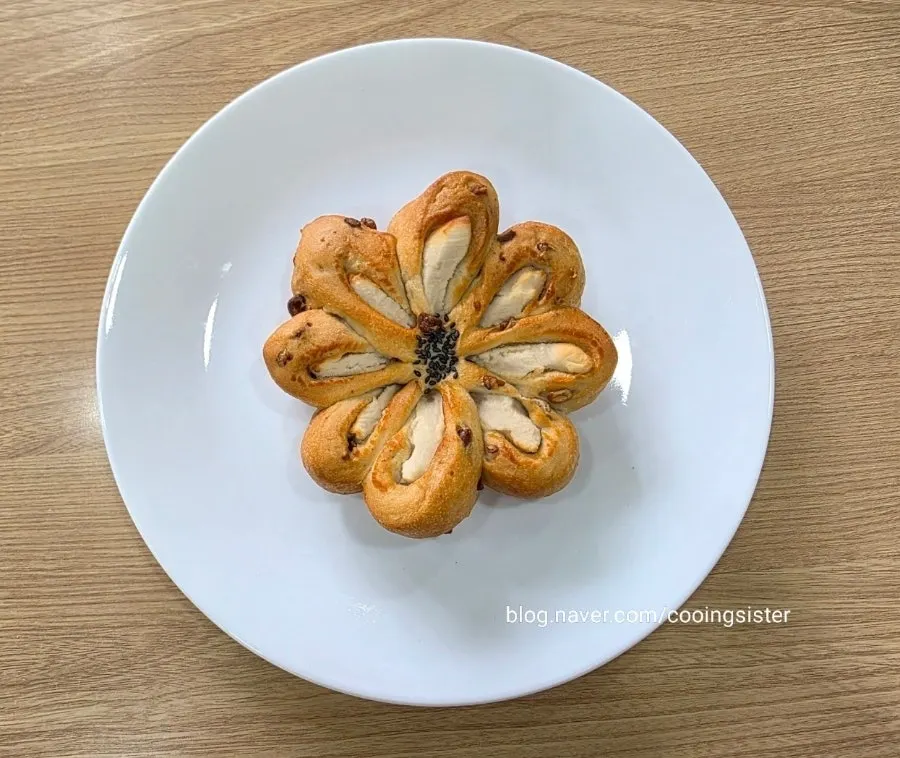 Flower-shaped white bean paste bread dotted with black sesame