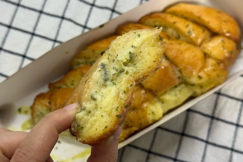 Cross-section of garlic bread soaked in garlic sauce