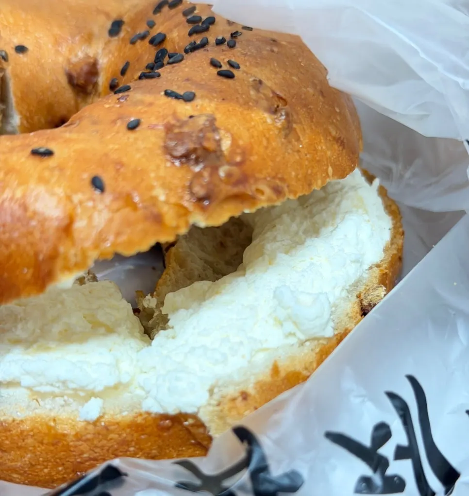 Cross-section of Munhwa Bakery's onion bagel with cream cheese