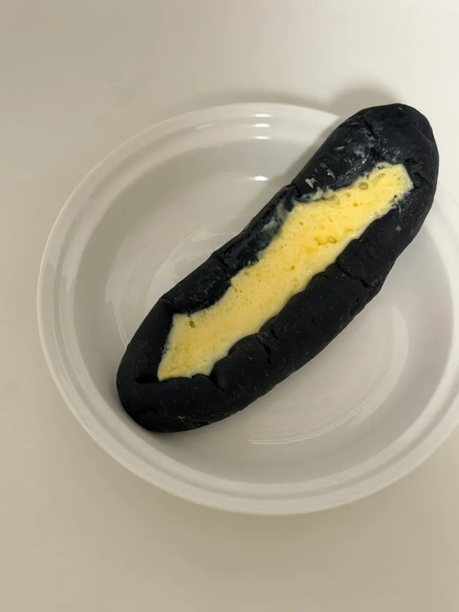 Squid ink custard bread, milk cream bread, and coffee bread packed for takeout