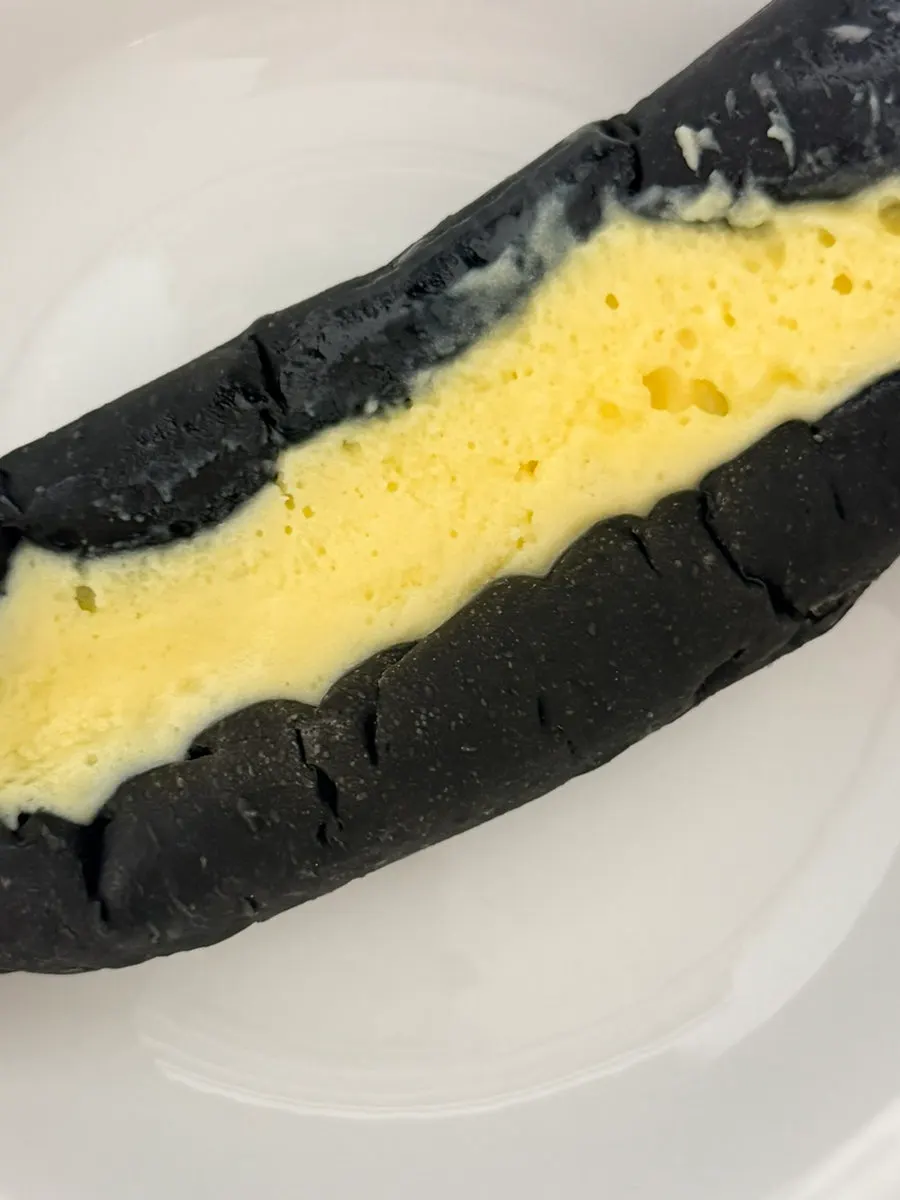 Custard cream inside a cross-section of squid ink custard bread