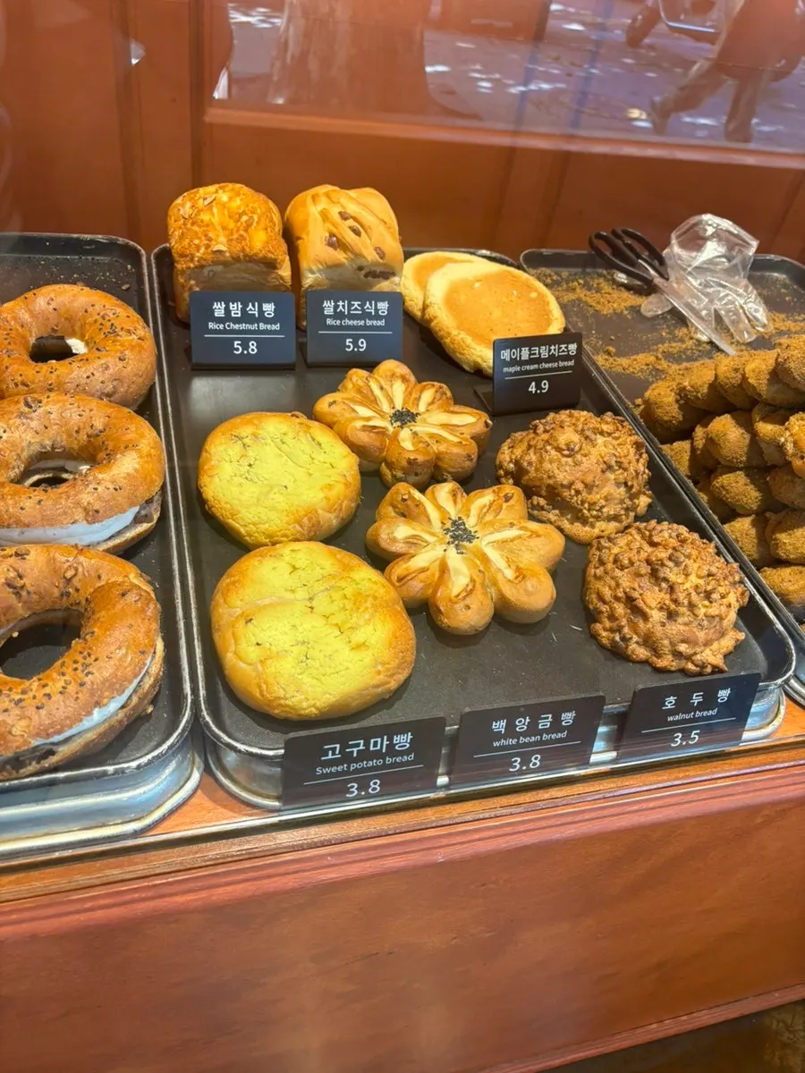 Onion bagels and loaf breads displayed at Munhwa Bakery