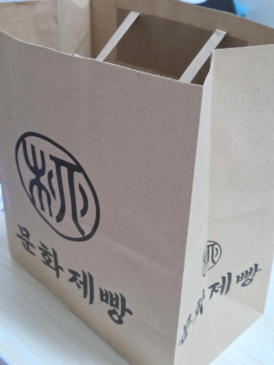 Holding the Munhwa Bakery takeout bag
