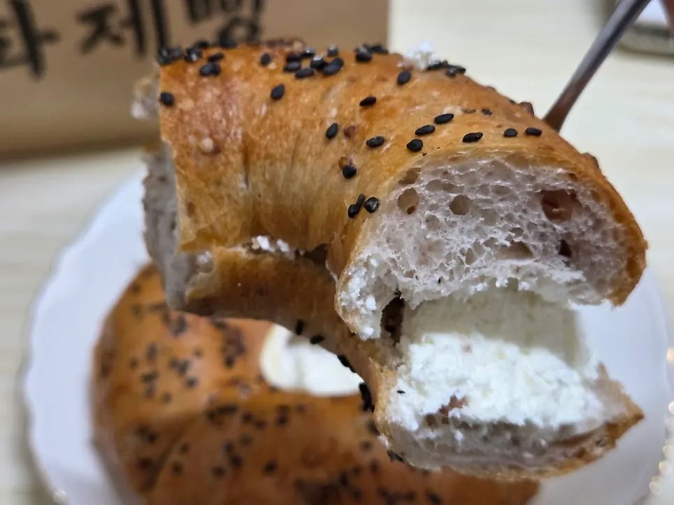 Onion cream filling inside a halved onion bagel