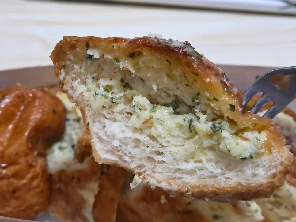 A cut piece of garlic bread showing the inside