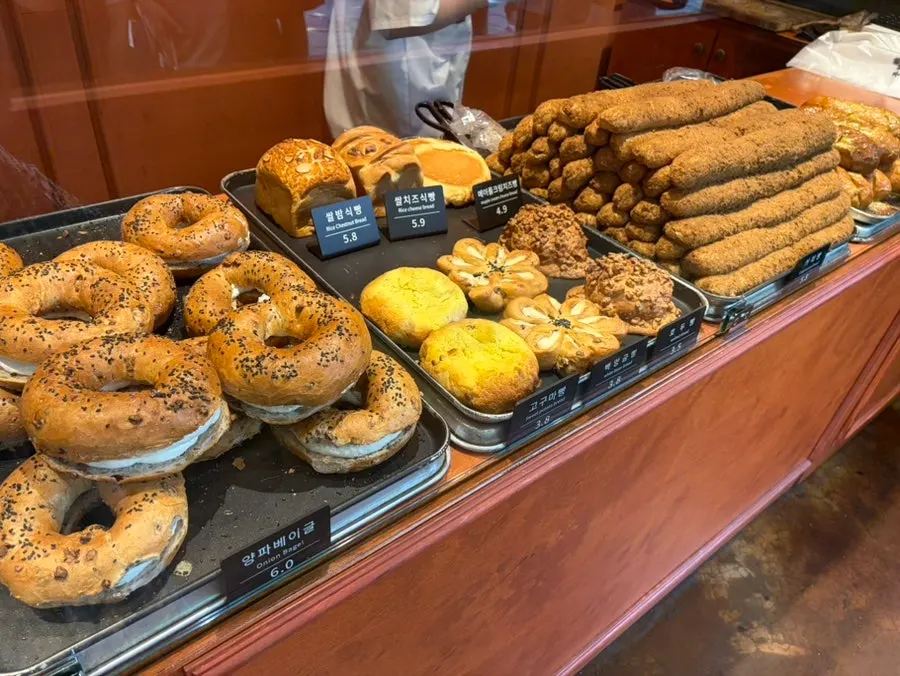 Rice loaf and bagels on the display shelf at Munhwa Bakery