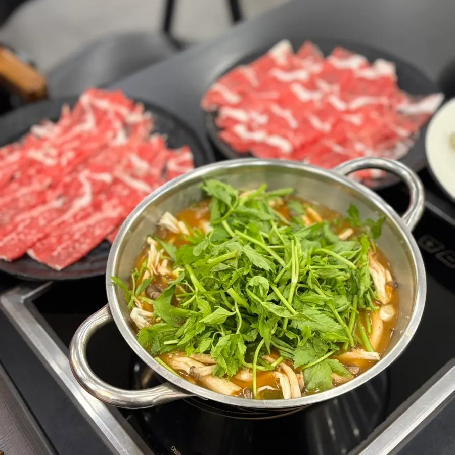 Kalguksu noodles being cooked in the broth