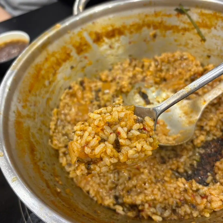 The pot of fried rice scraped clean to the bottom