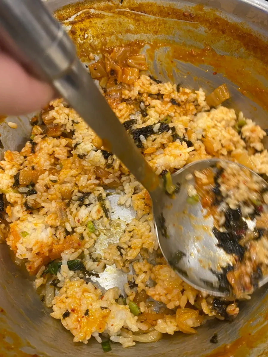 Fried rice cooking with stir-fried kimchi and gim on top
