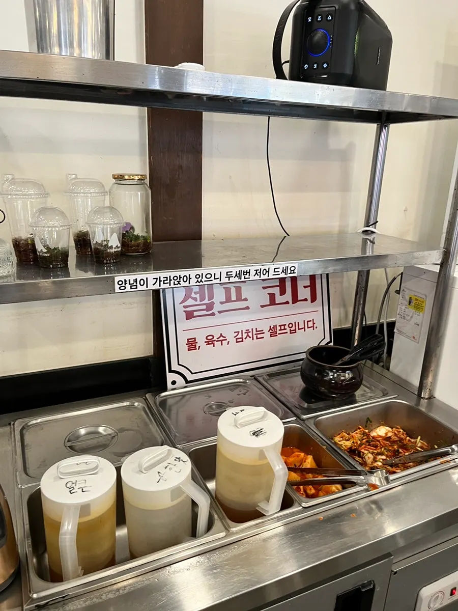 White-toned seating inside Munhyeon Shabu Kalguksu