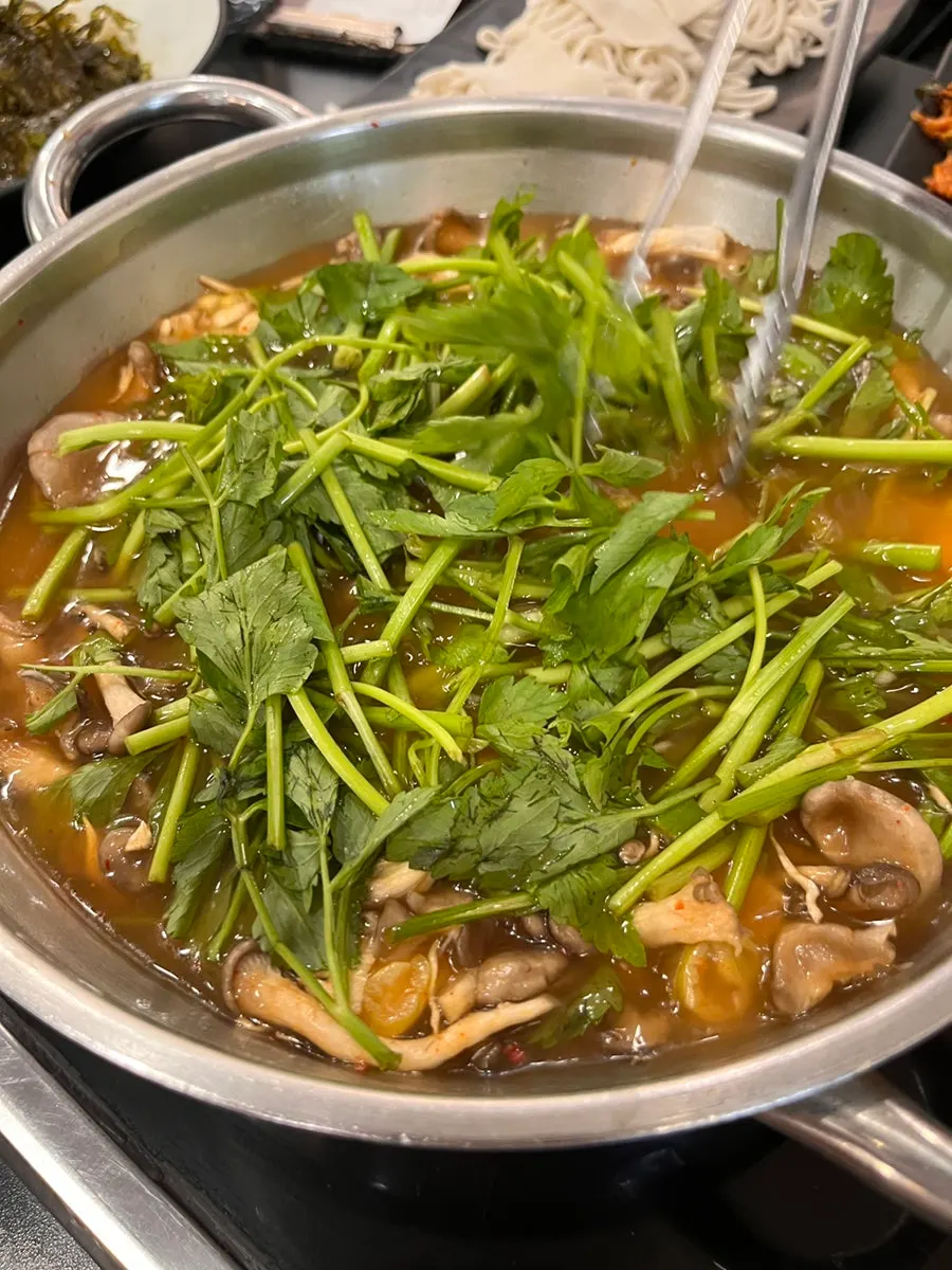 Table set with sirloin shabu-shabu, vegetables, and mushrooms