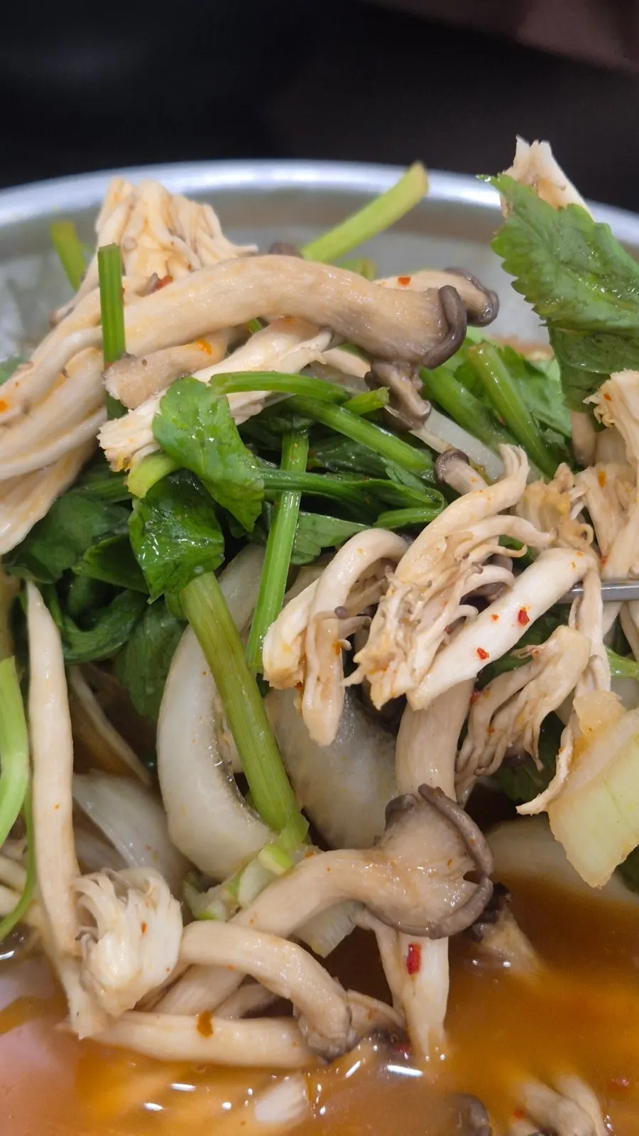 A pot full of mushrooms and vegetables