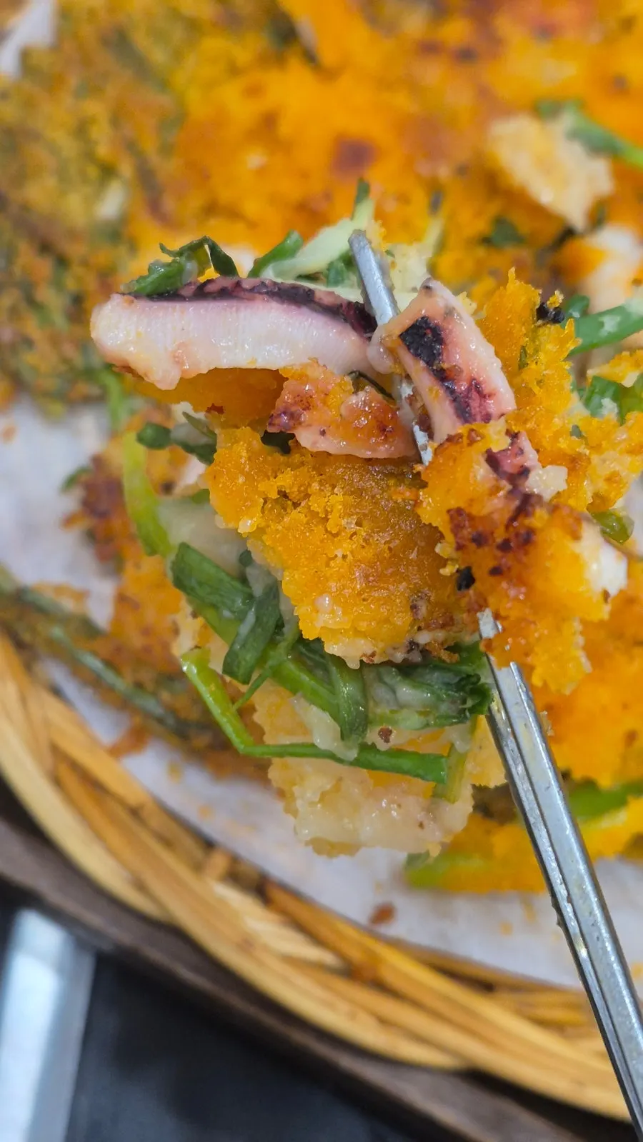 Cross-section of pajeon packed with green onion and seafood