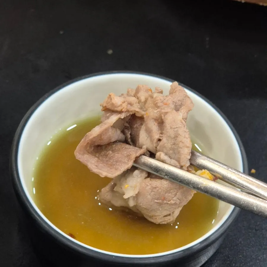 A piece of shabu meat blanched in the broth