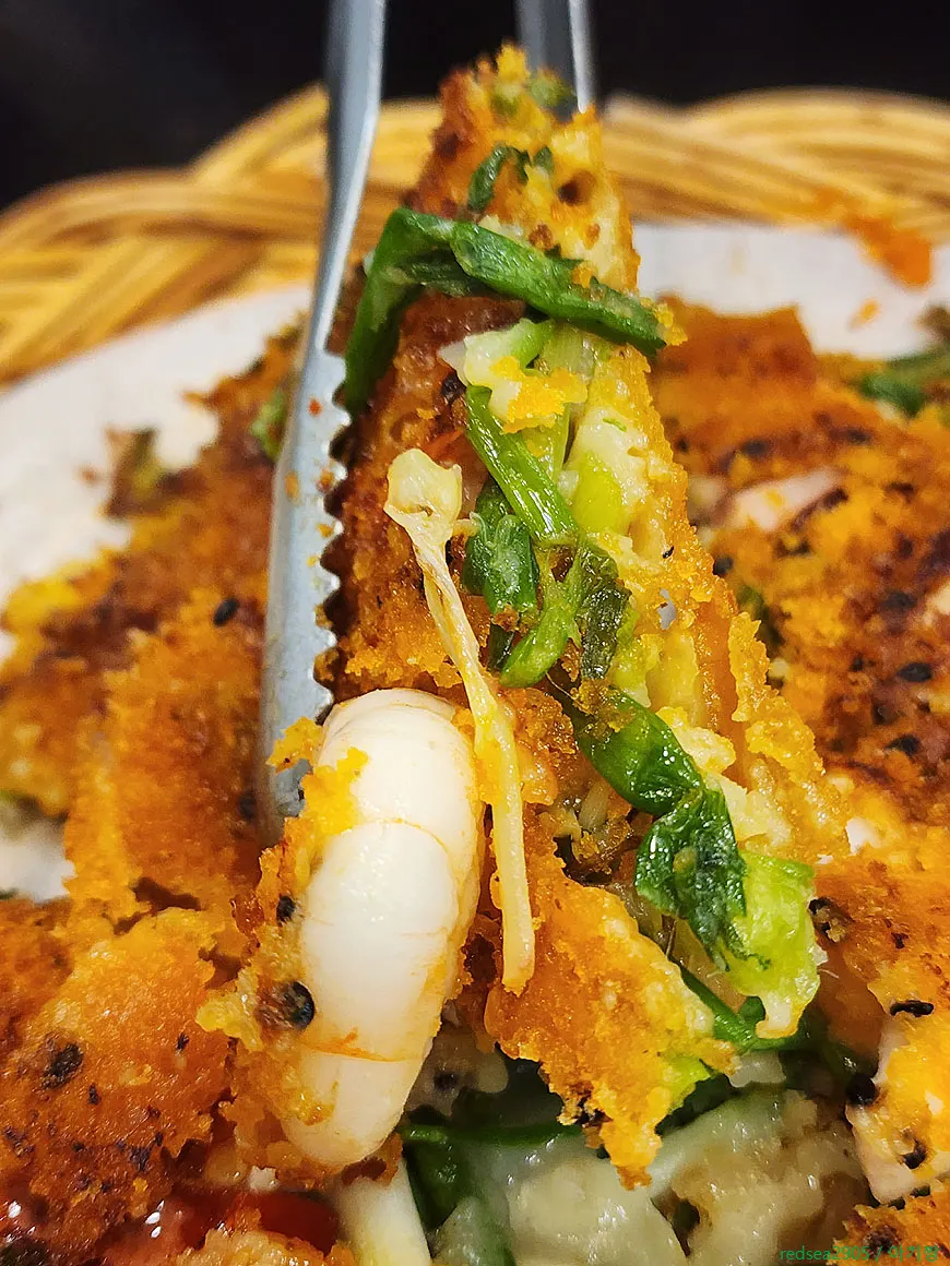 Cross-section of crispy pajeon packed with seafood