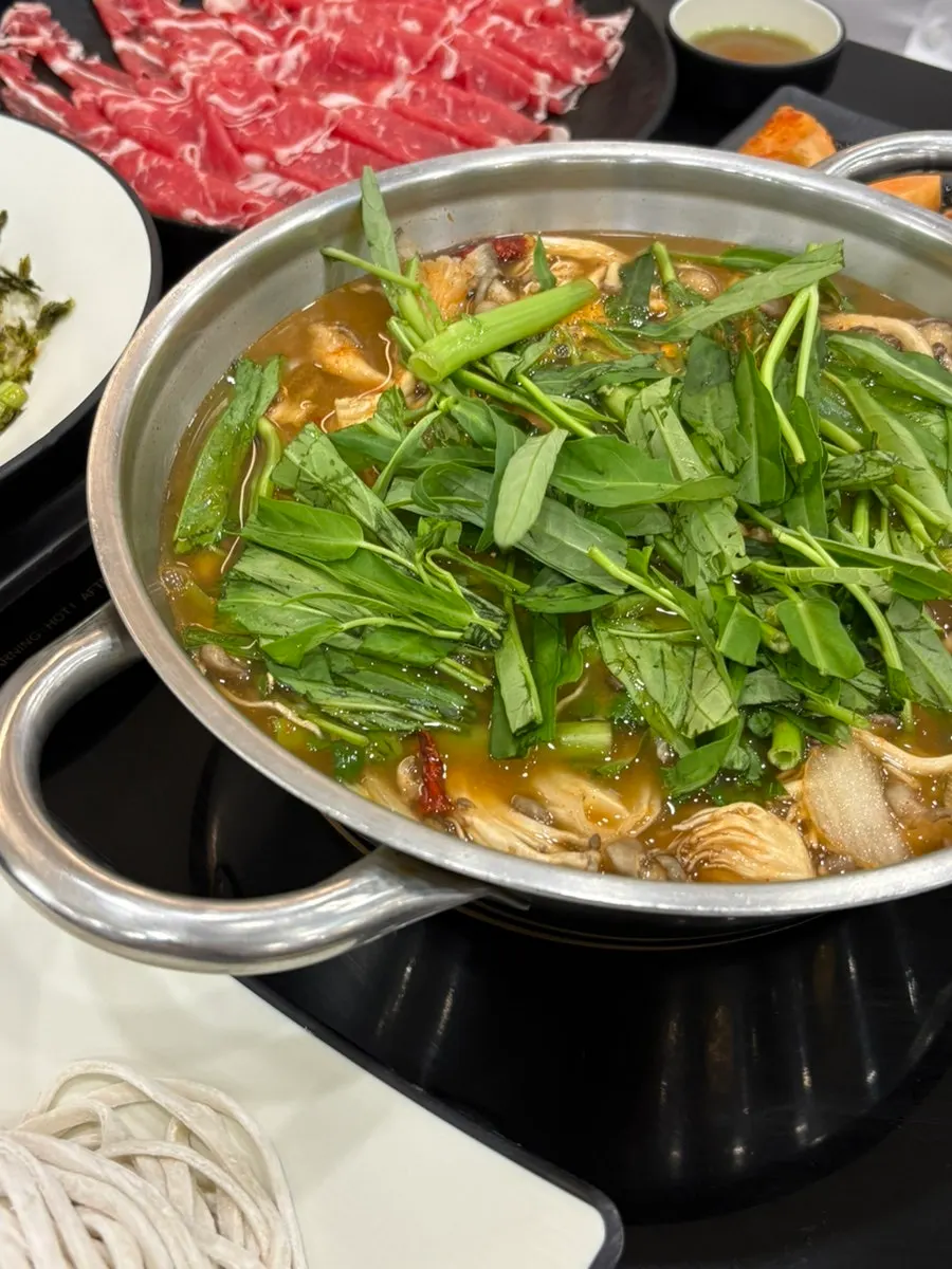 Shabu-shabu spread with sirloin and vegetables and mushrooms