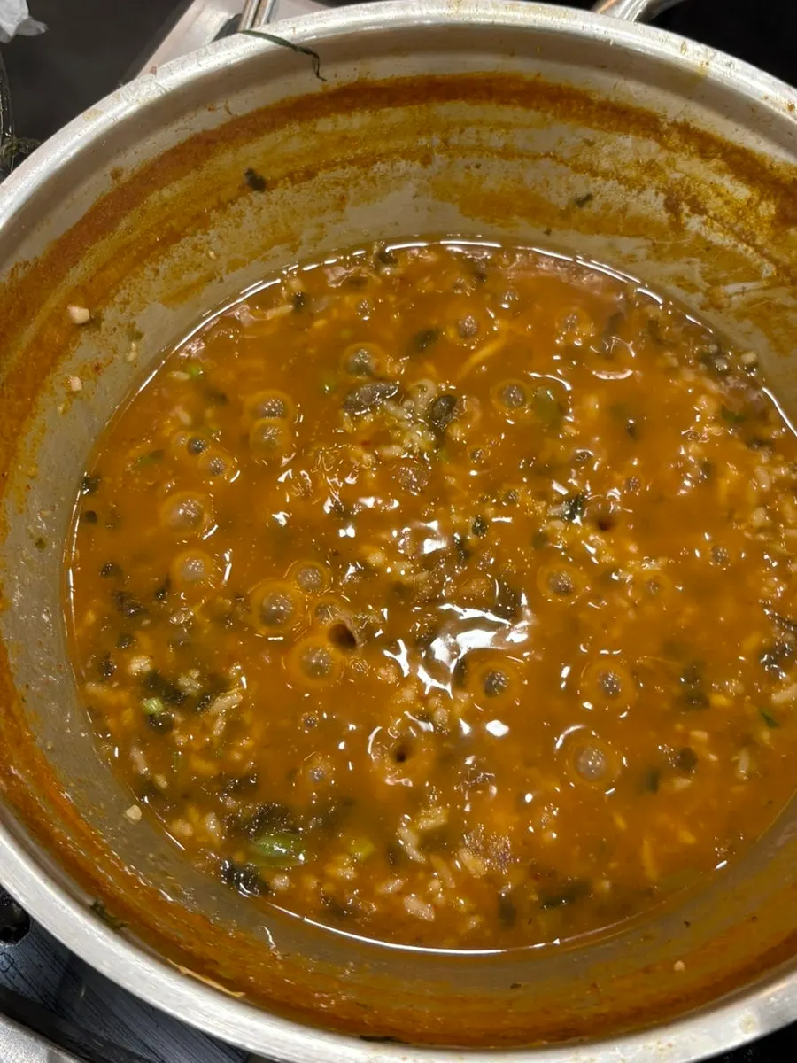 Thin sujebi and kalguksu noodles lifted out of the pot