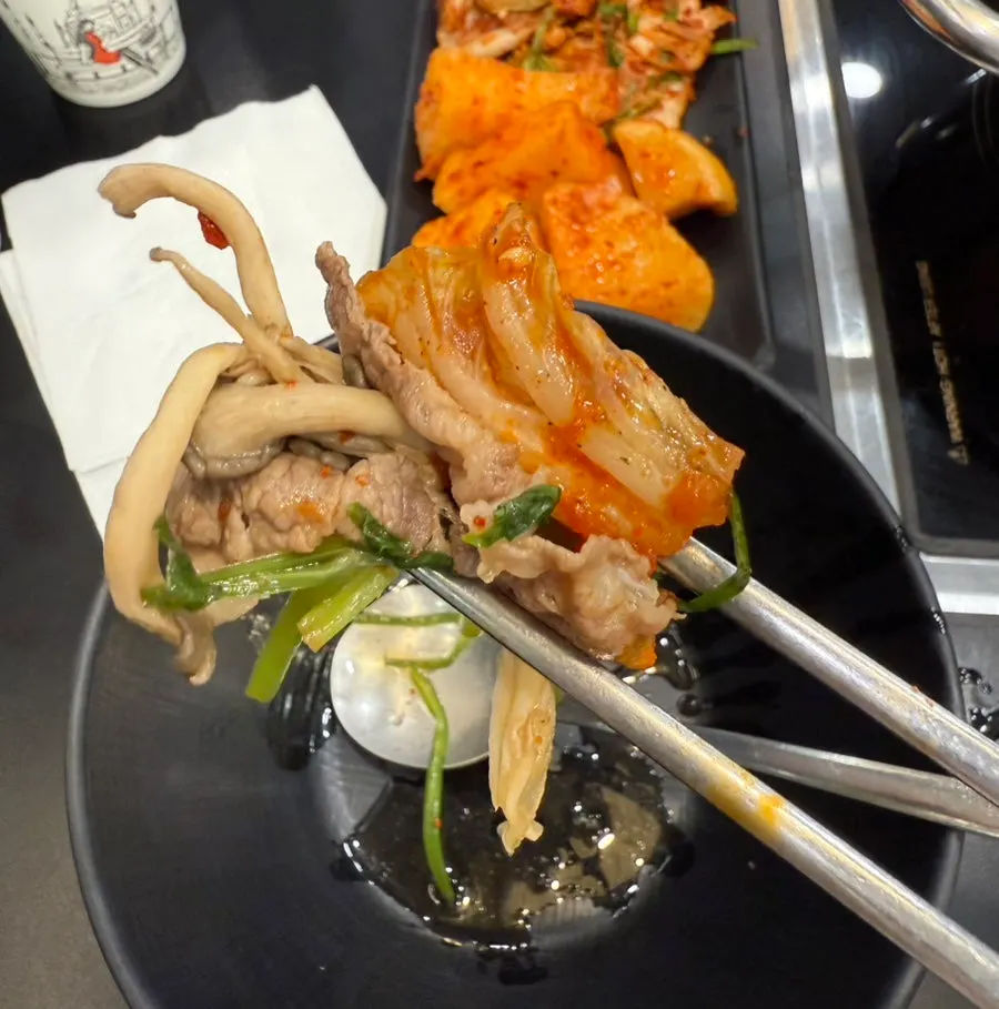 Plate of cooked beef and vegetables lifted out of the pot
