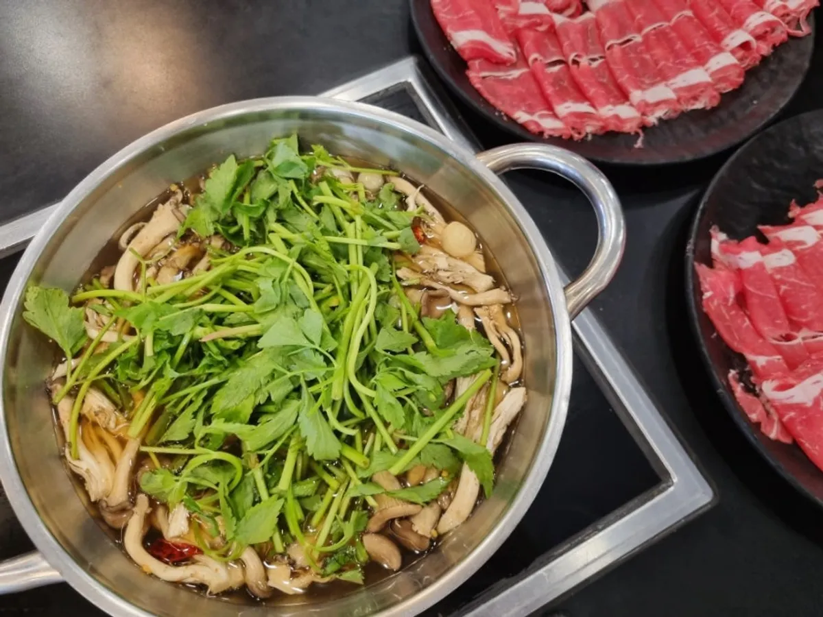 A spread of sirloin beef with minari and mushroom vegetables