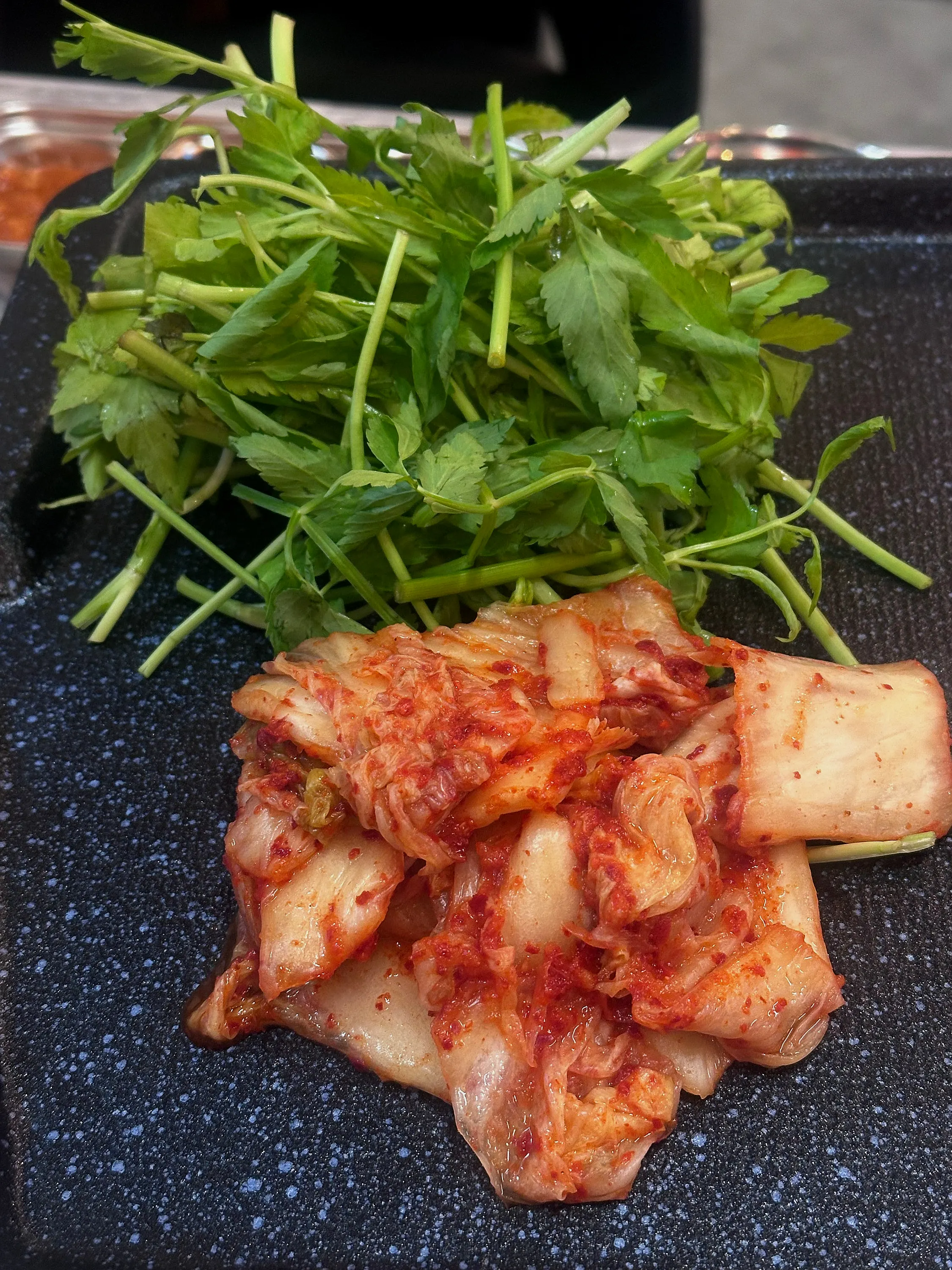 Thin frozen pork belly turning golden on the grill