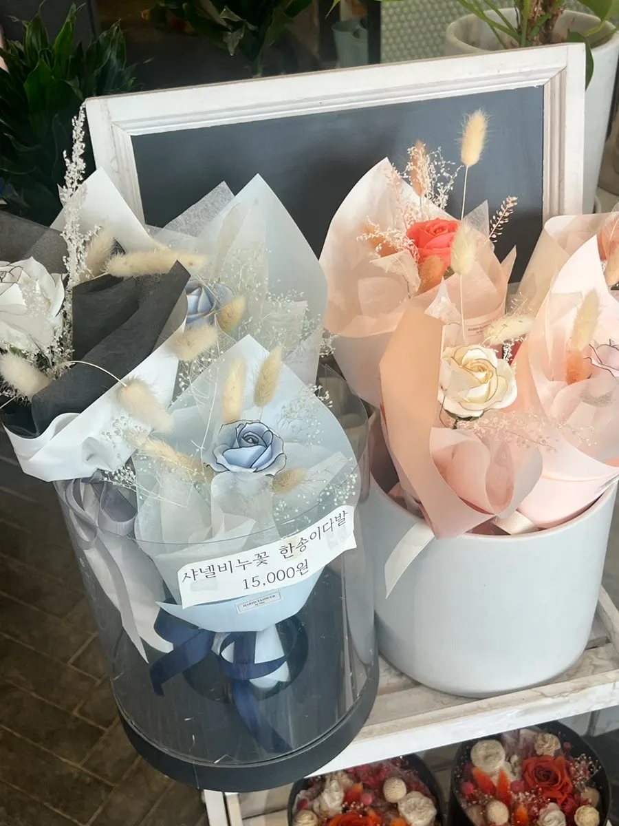 Bouquets displayed alongside gift items