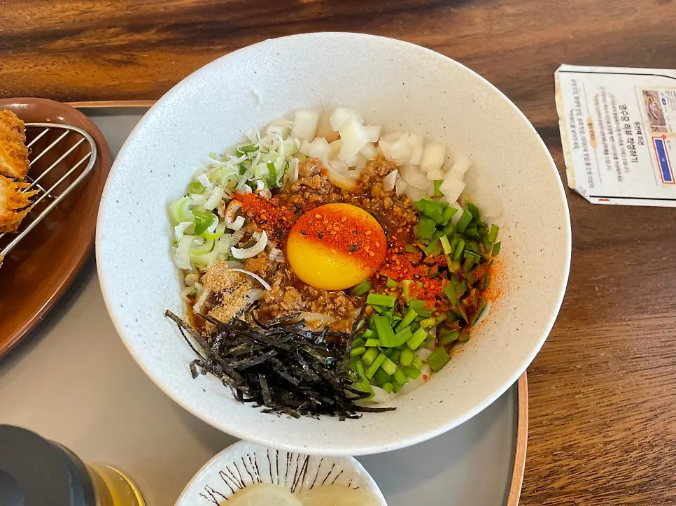 Mazemen topped with egg yolk and garnishes