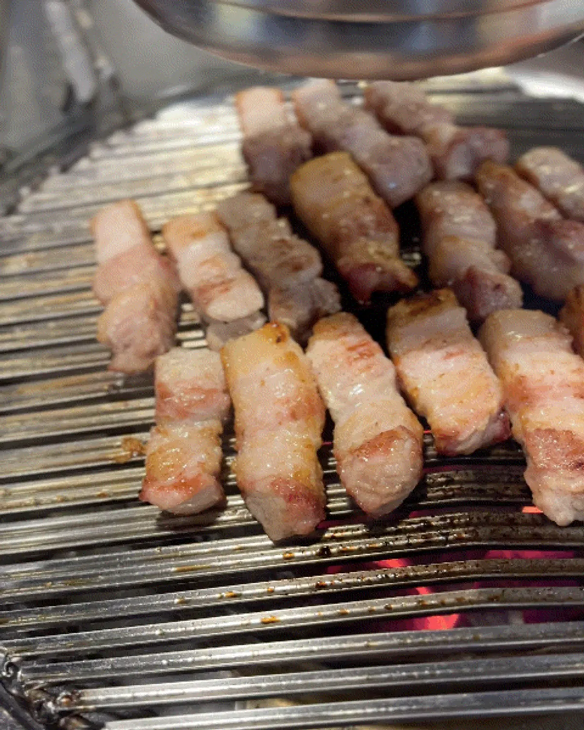 Pork belly cooking over charcoal at Insaengdwaeji Songpa Branch