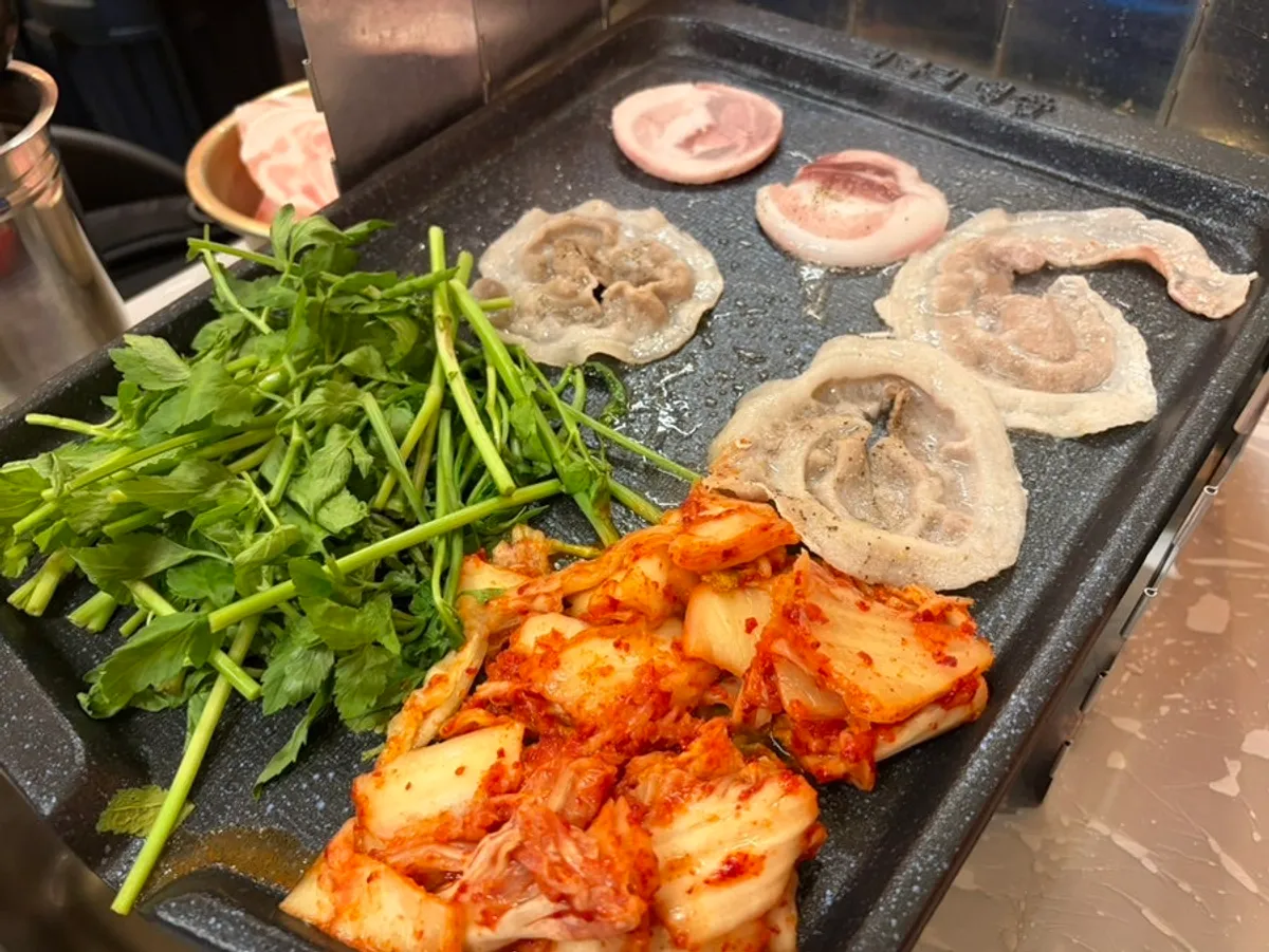 Flower-cut pork belly and minari sizzling on the grill