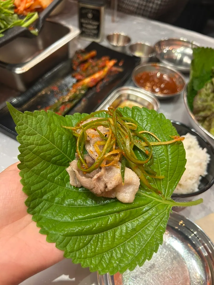 Pork belly grilling together with minari