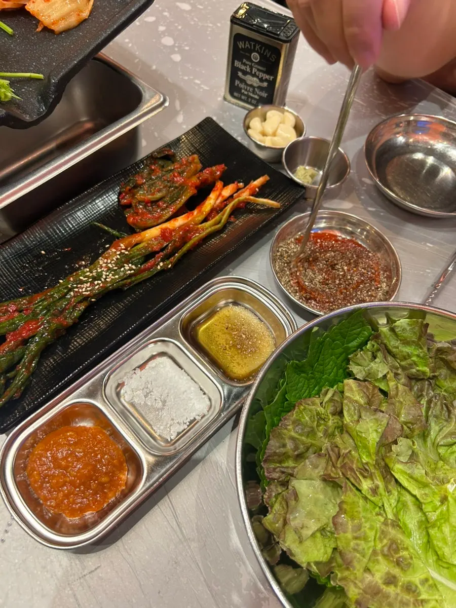 Gochujang sauce sprinkled with perilla seeds, served with minari