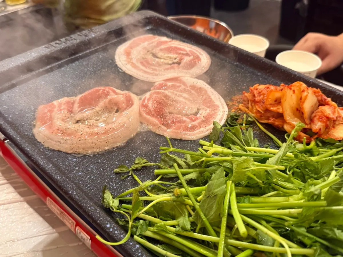 A table spread of minari and naengsam at Minari Naengsam near Munjeong Station