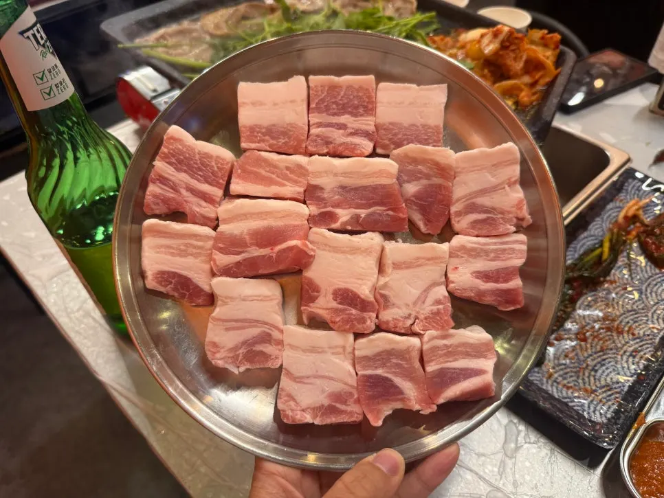 Minari naengsam pork belly grilling on the tabletop grill
