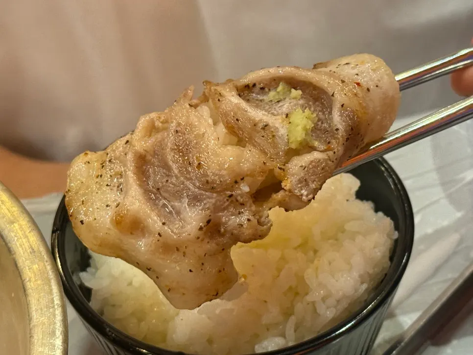A piece of naengsam wrapped in minari