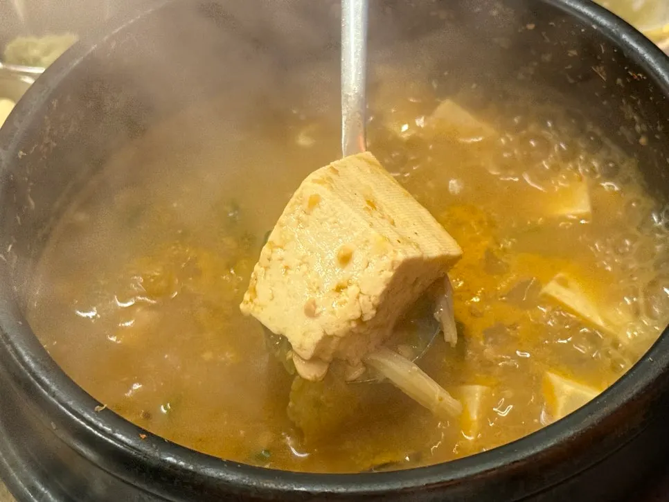 A stone pot of rustic cheonggukjang with tofu