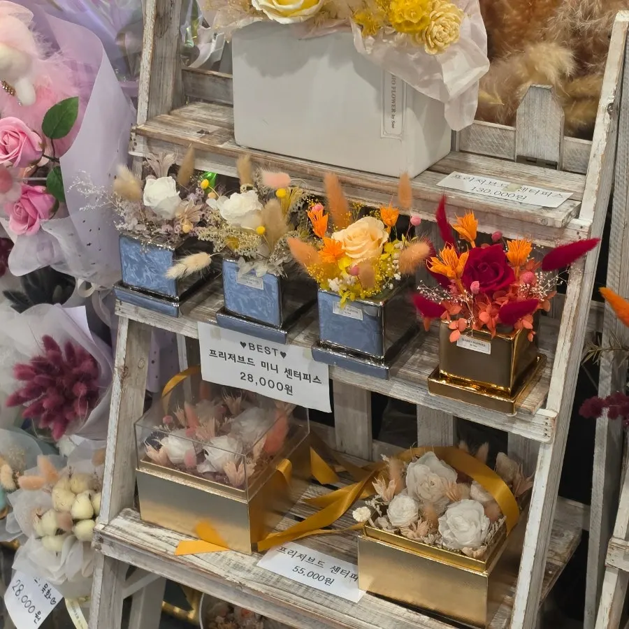 Flower-related items including centerpieces and potted plants