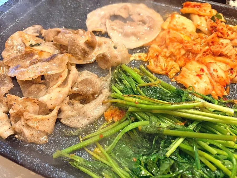Minari and kimchi grilled in pork fat