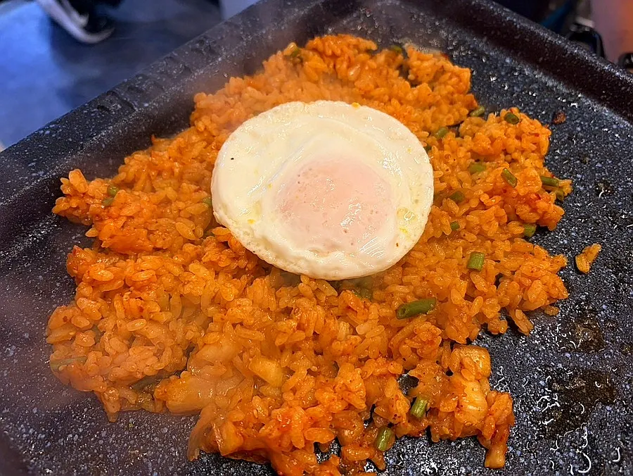 Soft-boiled egg placed on top of the fried rice
