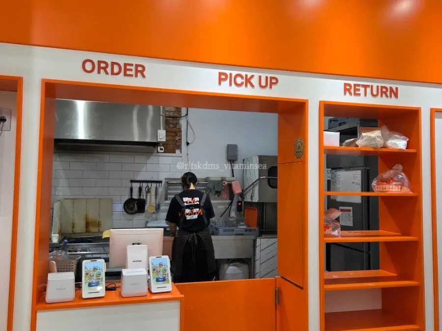 Olla Poke order and pickup counter with a staff member taking orders