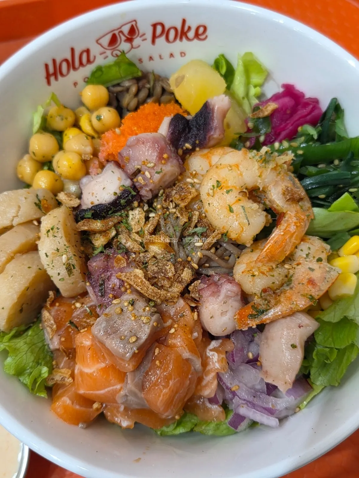 Close-up of seafood poke topped with a variety of seafood