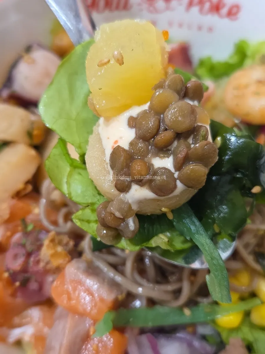 Detail of salad greens and seafood toppings