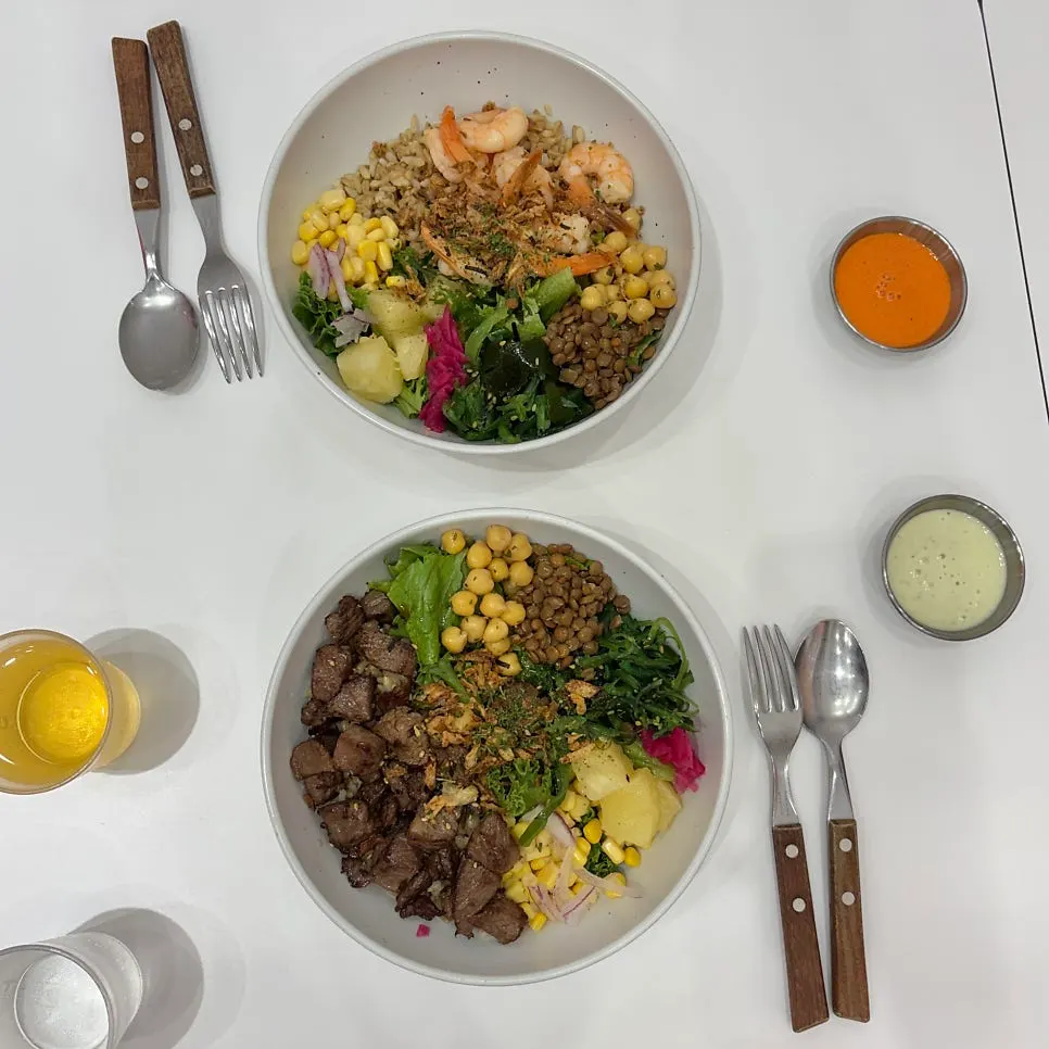 Table setting with Garlic Shrimp Poke and Steak Poke bowls
