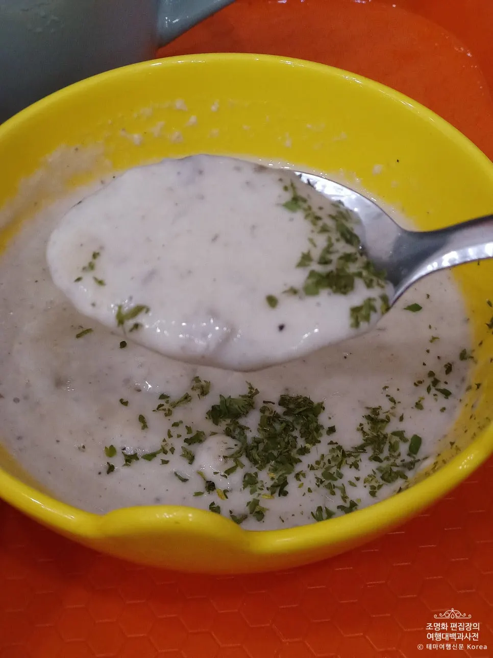 Vertical photo of a spoonful of mushroom soup