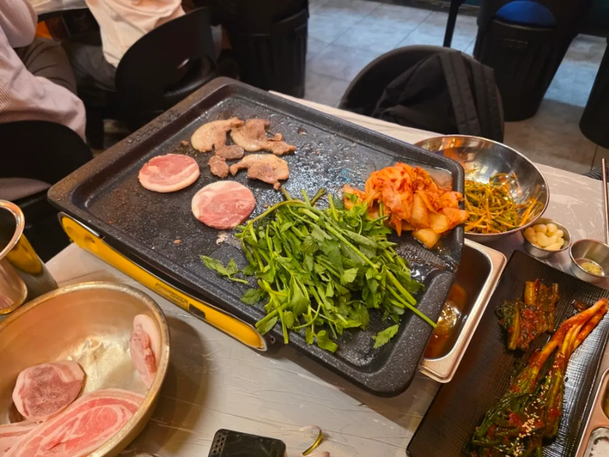 Minari and pork belly grilled together in pork fat