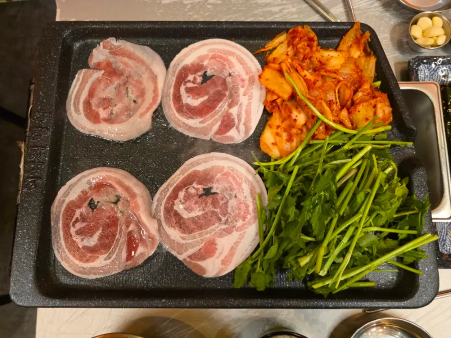 Frozen pork belly on the grill