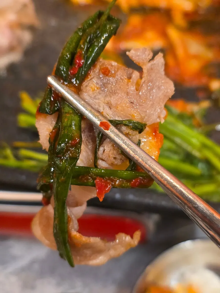 A piece of naengsam served with minari