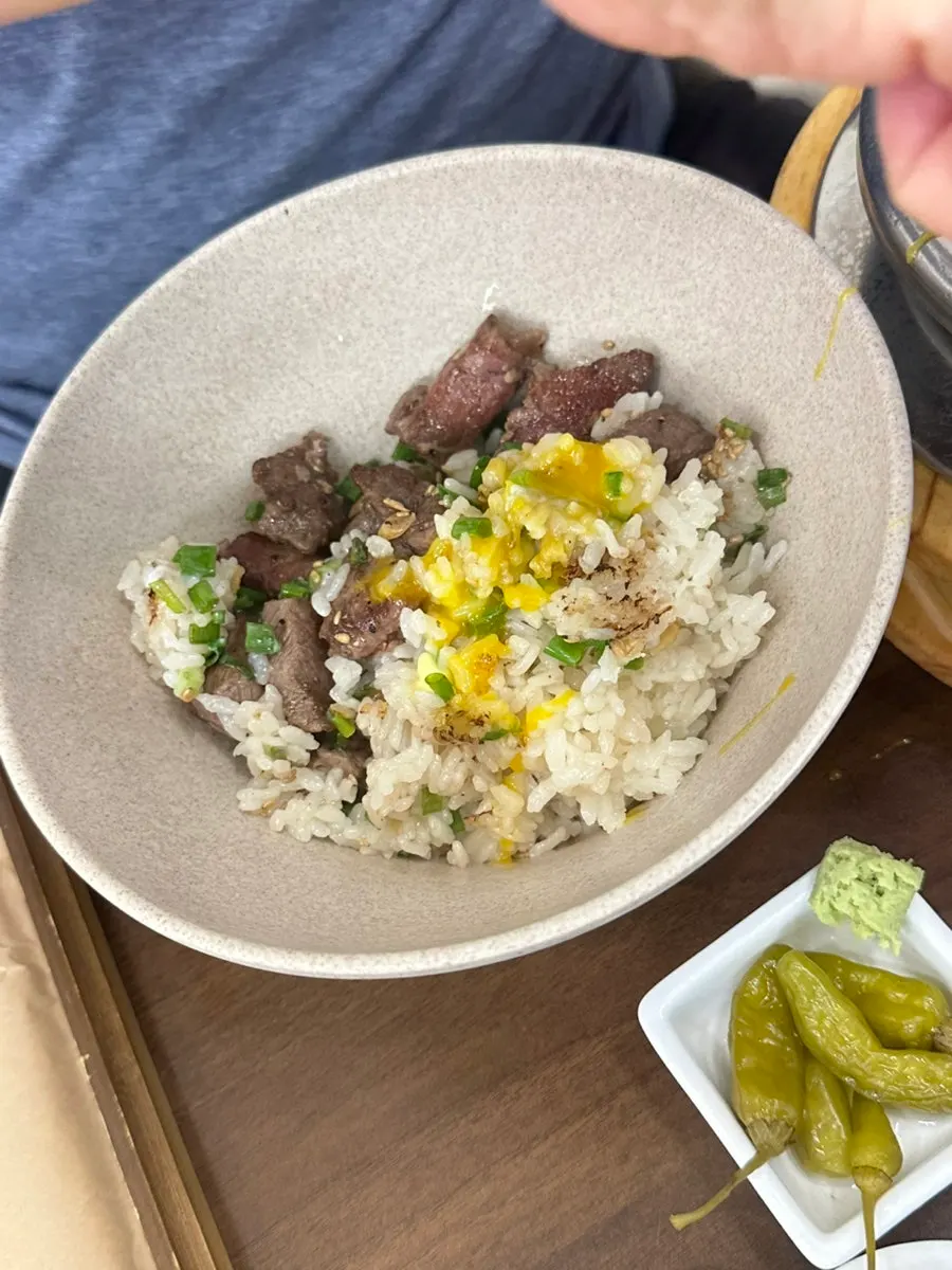 Close-up of the steak pot rice topped with egg yolk