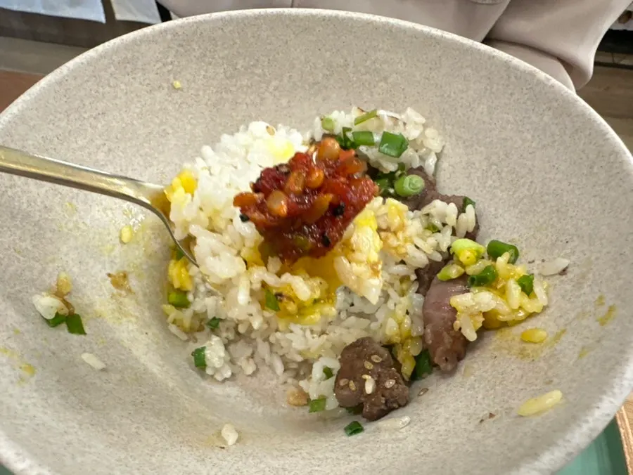 A spoonful of steak pot rice with special sauce